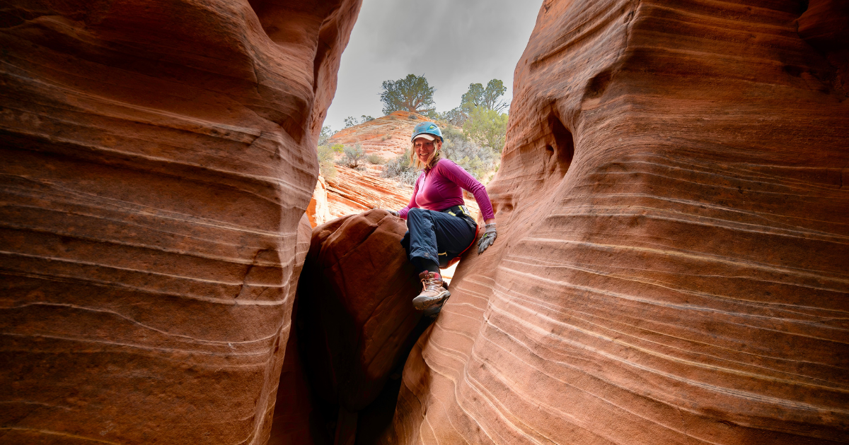 Climbing through Diana's Throne slot canyon near Zion National Park